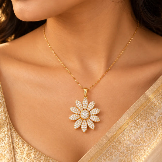Gold diamond flower pendant on a silk saree